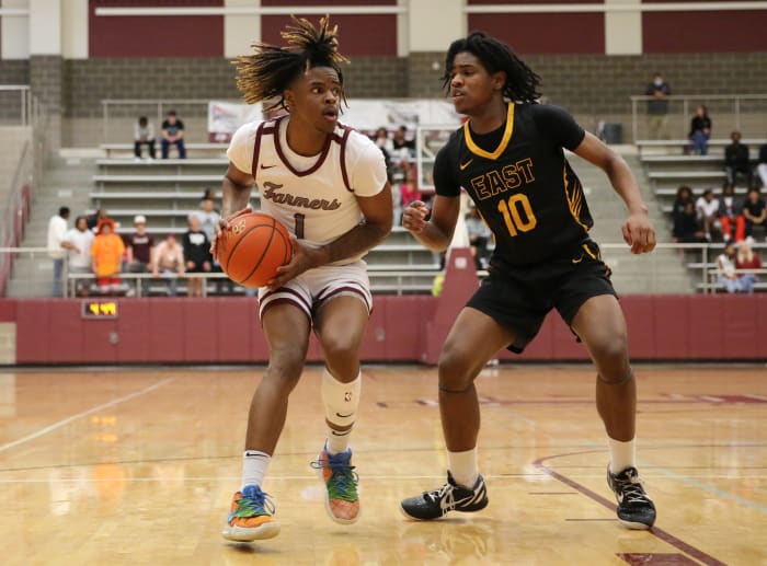Lewisville's Landon Brown drives the lane against Plano East's Xavier Miller in a January 2023 game between the Farmers and Panthers.